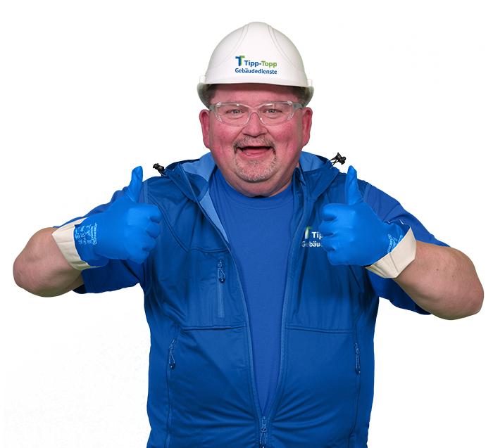 Ein Mitarbeiter für Baureinigung und Bauendreinigung in blauer Arbeitskleidung mit zwei Daumen hoch